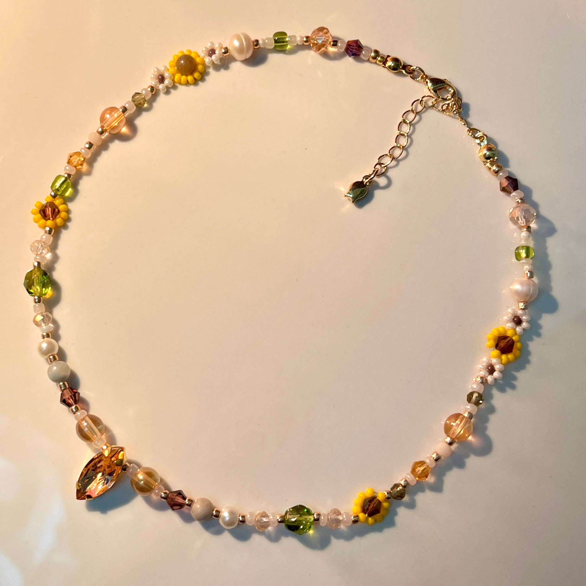 Necklace with sunflower-shaped beads on a light background